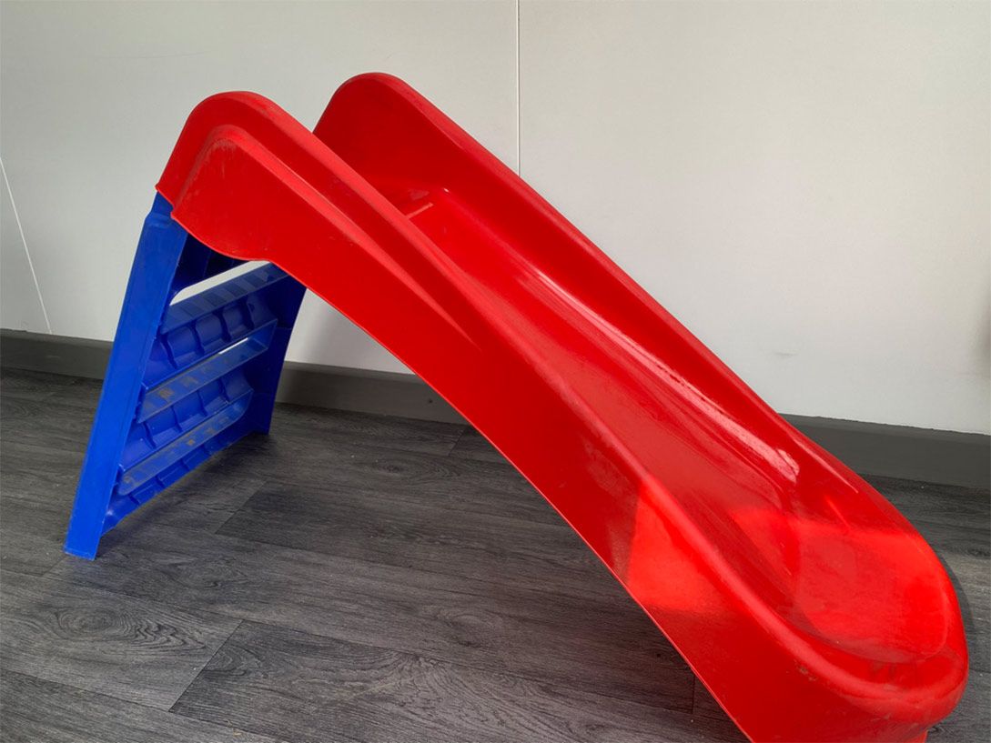 An image of a small, plastic children's slide 